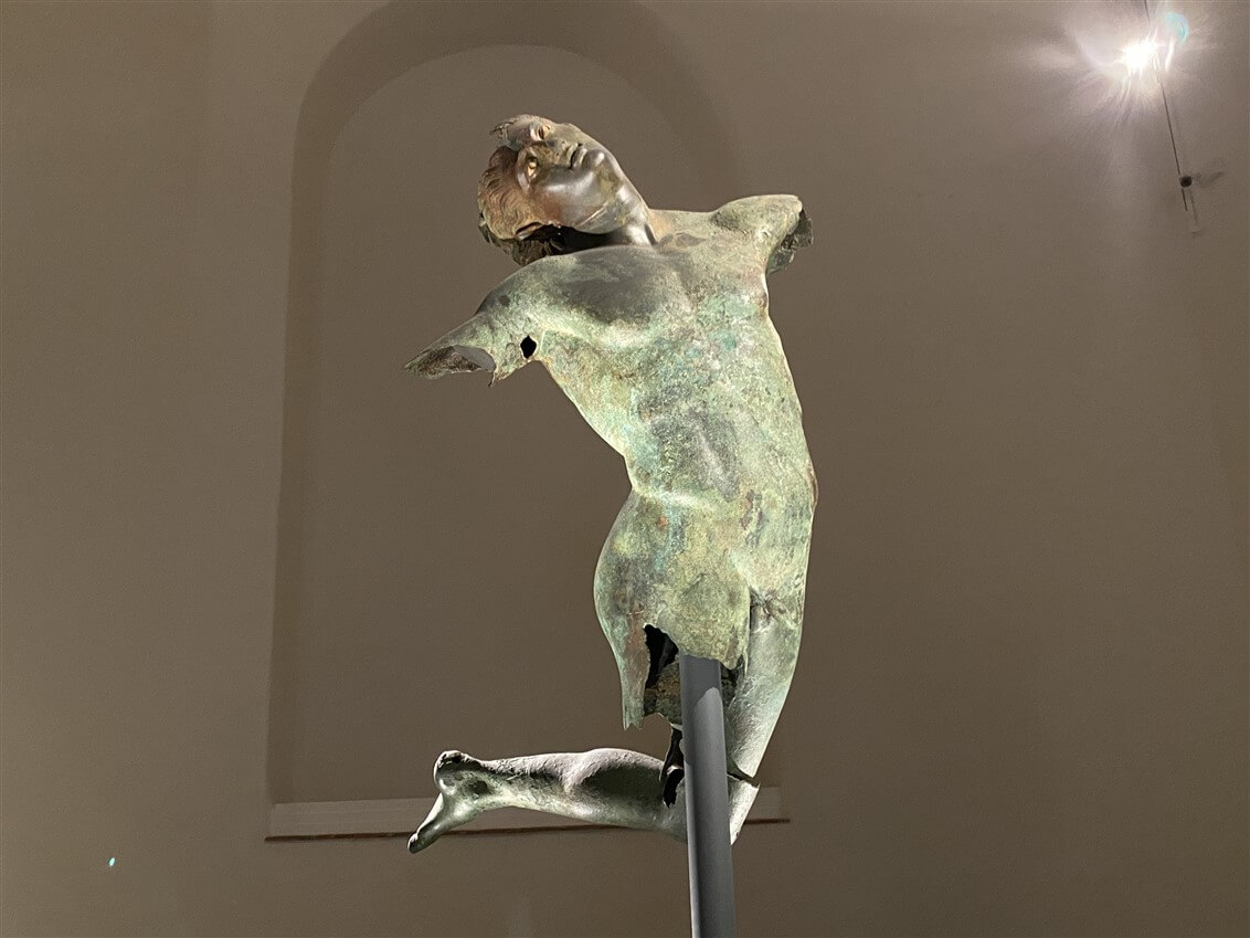 Ancient bronze statue displayed in a museum